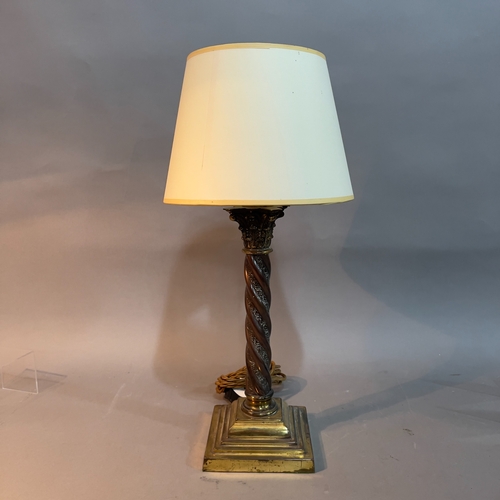 154 - A brass table lamp having a Corinthian topped turned column on stepped base, with shade 35cm high