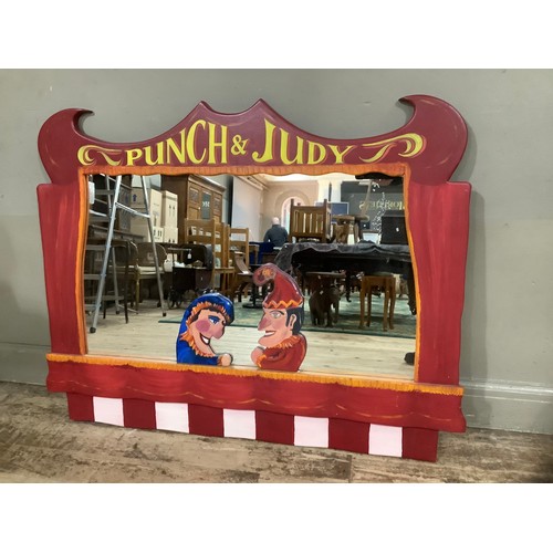 129 - A large wall mirror, the frame formed of Punch and Judy figures to the bottom and 'Punch and Judy' l... 