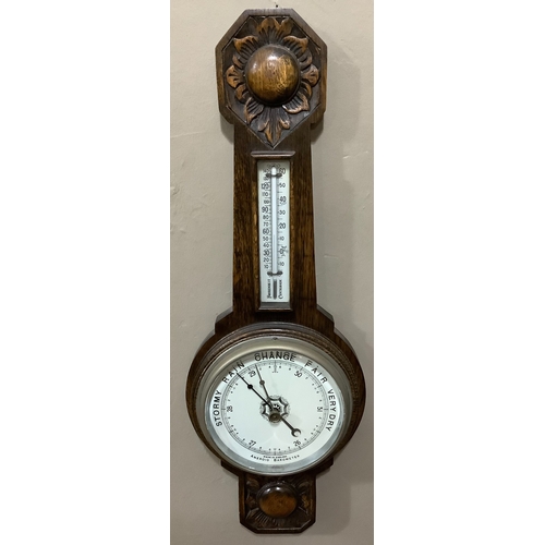 206 - An early 20th century carved oak wheel barometer