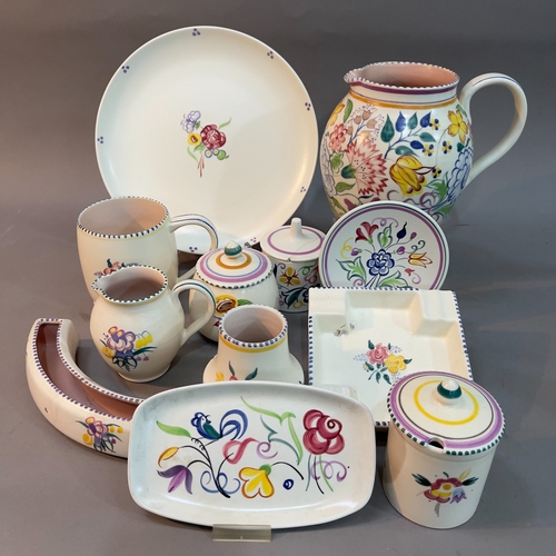 84 - A collection of Poole pottery comprising a jug painted with flowers BN pattern, preserve pot and cov... 