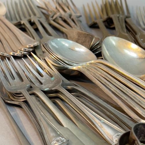 78 - A collection of silver plated and stainless steel cutlery comprising forks, soup spoons, serving spo... 