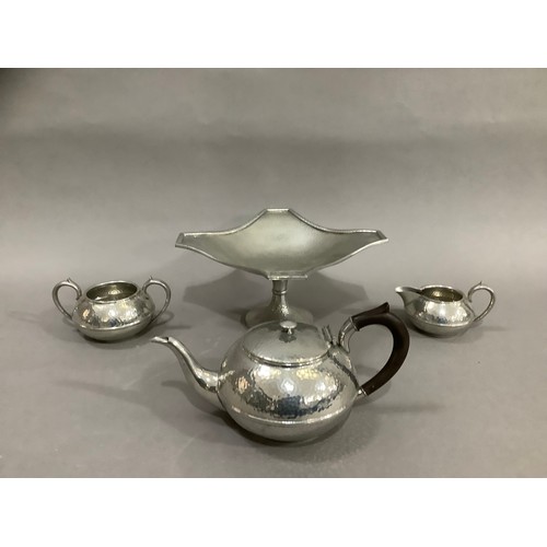 72 - A Civic pewter planished tea service comprising a teapot, milk jug, twin handled sugar bowl together... 