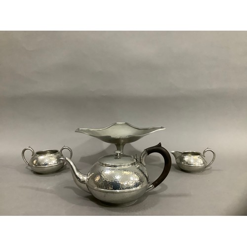 72 - A Civic pewter planished tea service comprising a teapot, milk jug, twin handled sugar bowl together... 