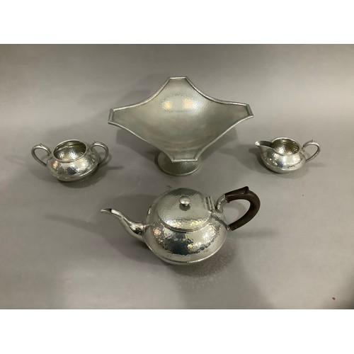 72 - A Civic pewter planished tea service comprising a teapot, milk jug, twin handled sugar bowl together... 