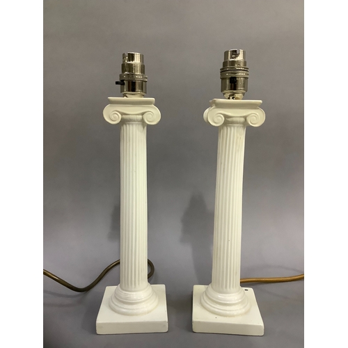 126 - Two cream ceramic table lamps formed as colums on stepped bases