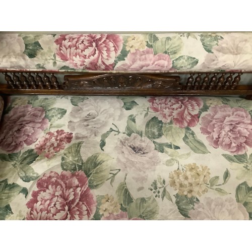 255 - A late Victorian stained beech chaise lounge with spindle back, upholstered in printed floral Heming... 