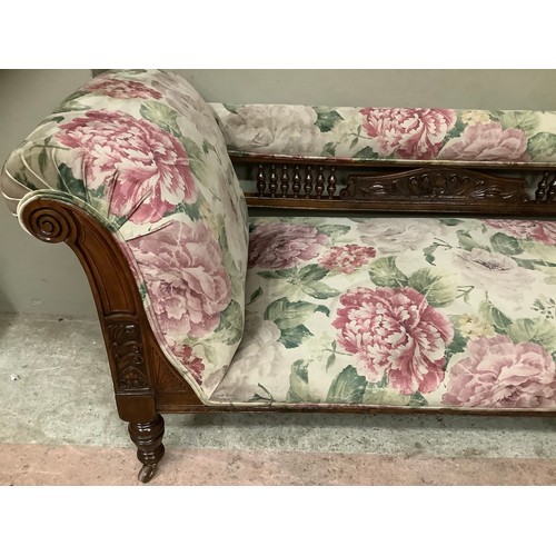 255 - A late Victorian stained beech chaise lounge with spindle back, upholstered in printed floral Heming... 