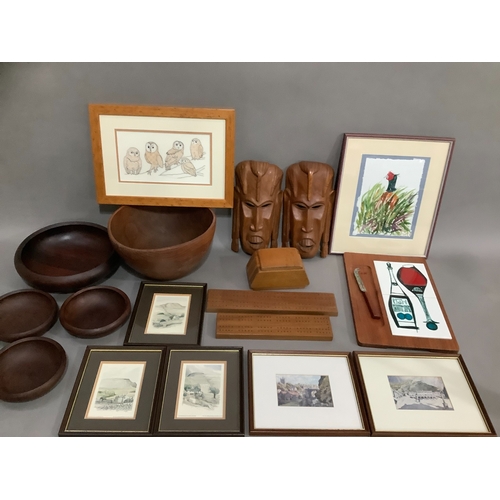 114 - A collection of carved bowls, a tribal mask and a collection of pictures