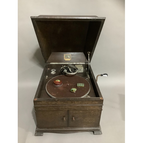 132 - A His Masters Voice portable record player, with tin of needles