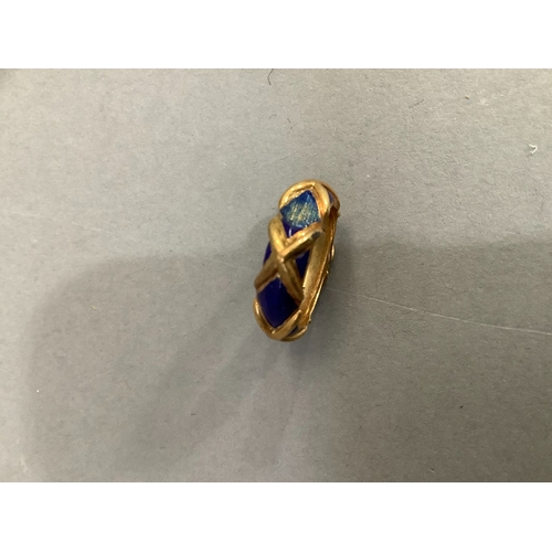 201 - An enamel band ring (at fault) in yellow metal (tests as 14ct gold), approximate weight 6g