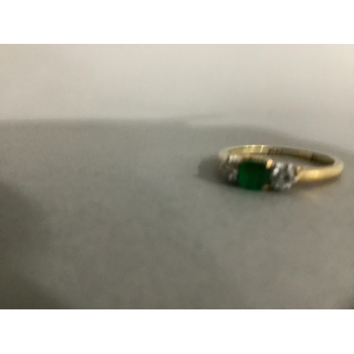 204 - A three stone emerald and diamond ring, circa 1950, in 18ct gold and platinum, claw set to the centr... 