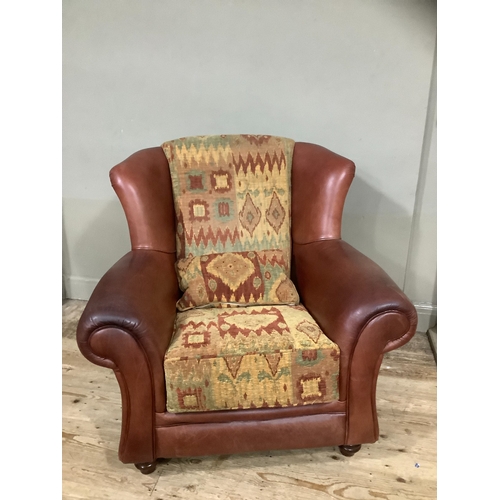 244 - A leather and kilim armchair and cushion