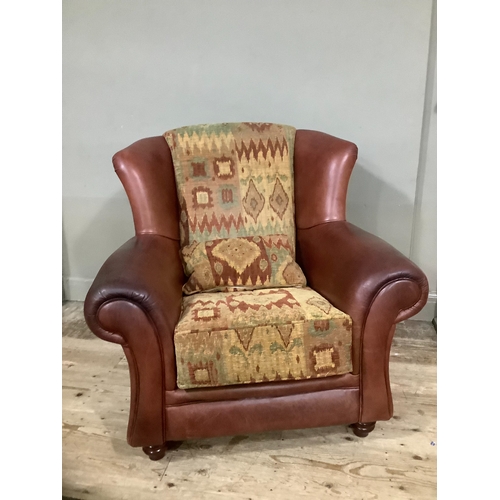 244 - A leather and kilim armchair and cushion