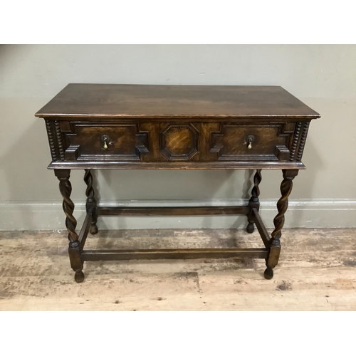 245 - An early 20th century oak side table, the drawer having geometric moulding on barley twist and squar... 