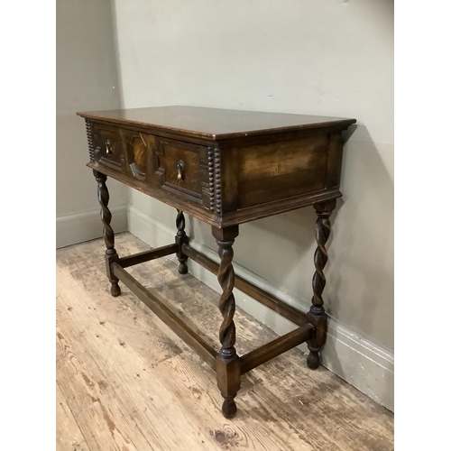 245 - An early 20th century oak side table, the drawer having geometric moulding on barley twist and squar... 