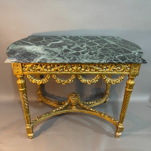 250 - A continental marble and giltwood table, of rectagular form with semi bowed ends, having a carved an... 