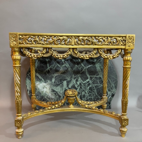 250 - A continental marble and giltwood table, of rectagular form with semi bowed ends, having a carved an... 