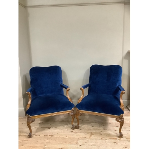 257 - A pair of mid 18th century style walnut open armchairs, upholstered in blue plush with open down swe... 