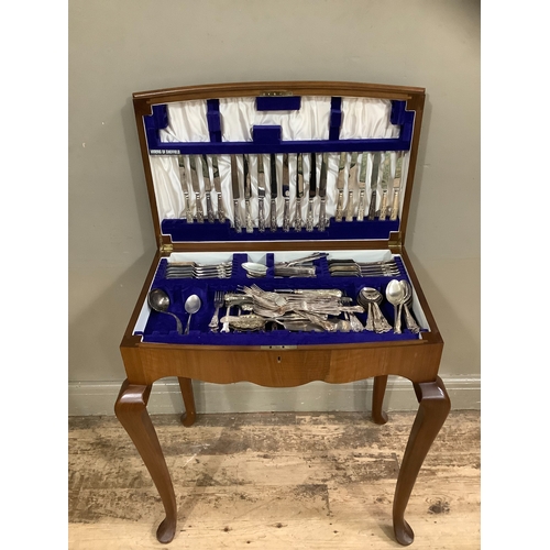 258 - A walnut table canteen containing associated sets of kings pattern EPNS cutlery