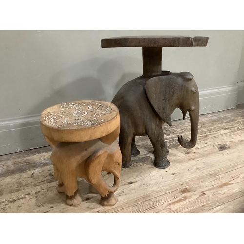 264 - An African hardwood stool, the support carved as an elephant together with a smaller example, the se... 