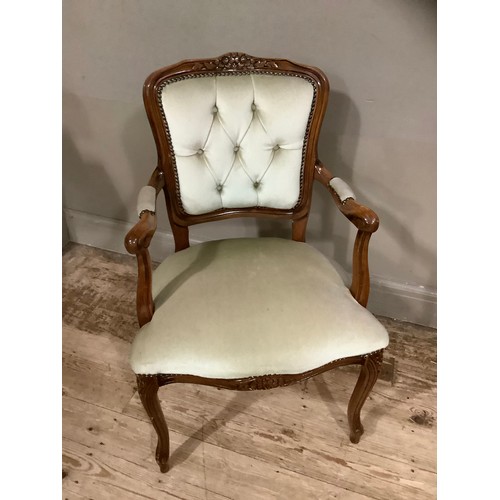 239 - A French style walnut open armchair with encircling frame and cream upholstery on cabriole legs