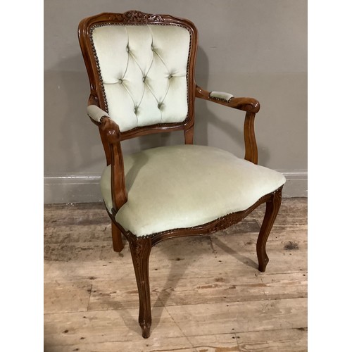 239 - A French style walnut open armchair with encircling frame and cream upholstery on cabriole legs