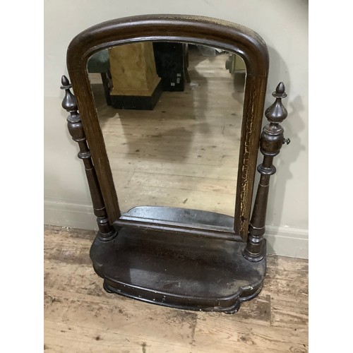 218 - A mid 19th century toilet mirror, arched glass on turned supports with a drawer to the platform base... 