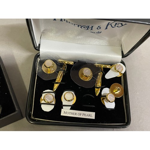 173 - A collection of three dress sets each of cufflinks and shirt studs in gilt and rose base metal vario... 