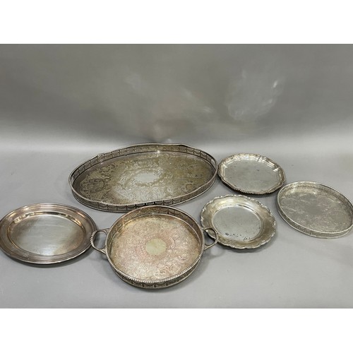 149 - A silver plated on copper galleried tray with etched centre, a twin handles tray with gadroon rim, s... 