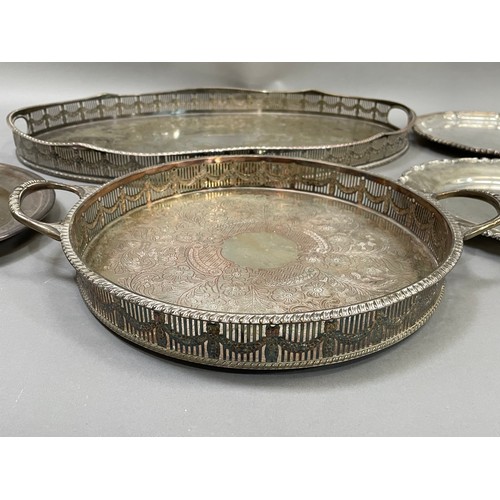 149 - A silver plated on copper galleried tray with etched centre, a twin handles tray with gadroon rim, s... 