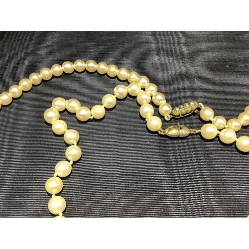 201B - A cultured pearl necklace, the 6.5mm pearls fastened with a base metal strap, approximate length 45c... 