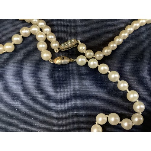 201B - A cultured pearl necklace, the 6.5mm pearls fastened with a base metal strap, approximate length 45c... 