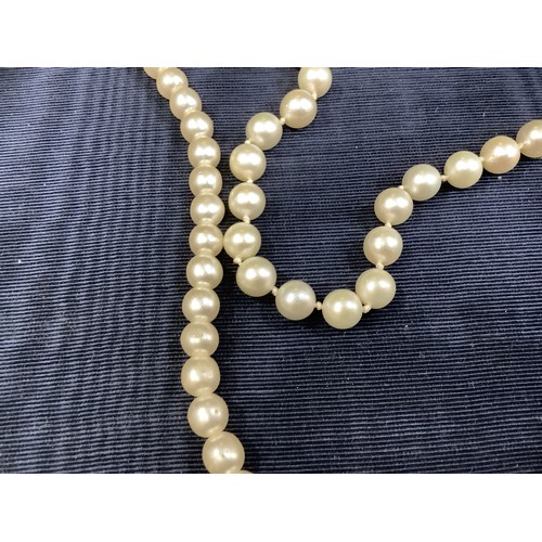 201B - A cultured pearl necklace, the 6.5mm pearls fastened with a base metal strap, approximate length 45c... 