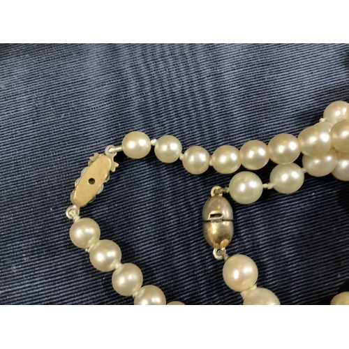 201B - A cultured pearl necklace, the 6.5mm pearls fastened with a base metal strap, approximate length 45c... 