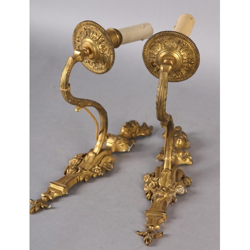 44 - A PAIR OF GILT METAL WALL SCONES CAST with the bust of an emperor and empress above a floral swagged... 