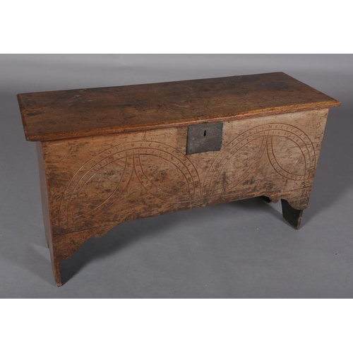 364 - A MID 17TH CENTURY OAK BOARDED CHEST, the single plank top over the carved front, incised demi-lunes... 