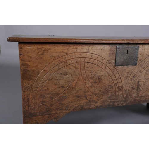 364 - A MID 17TH CENTURY OAK BOARDED CHEST, the single plank top over the carved front, incised demi-lunes... 