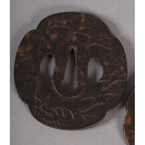 130 - A JAPANESE IRON TSUBA cast in relief with a dragon breathing flames of yellow metal, 7.5cm x 7cm, to... 