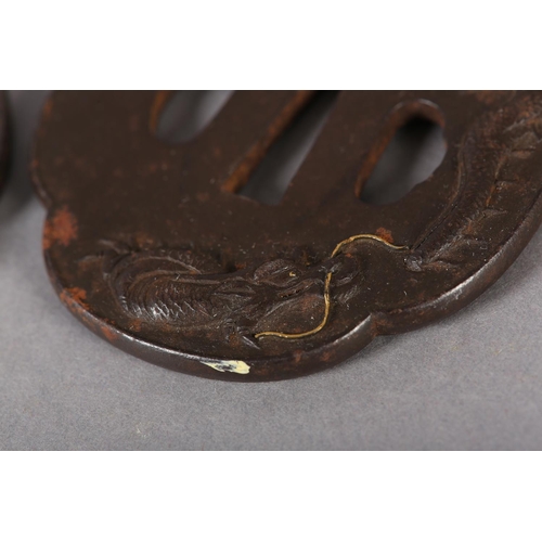 130 - A JAPANESE IRON TSUBA cast in relief with a dragon breathing flames of yellow metal, 7.5cm x 7cm, to... 