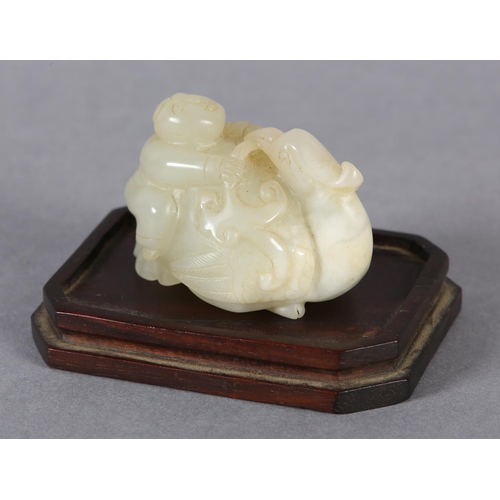 116 - A CHINESE JADE CARVING OF A BOY CLIMBING UPON THE BACK OF A PHOENIX with its head turned backwards h... 