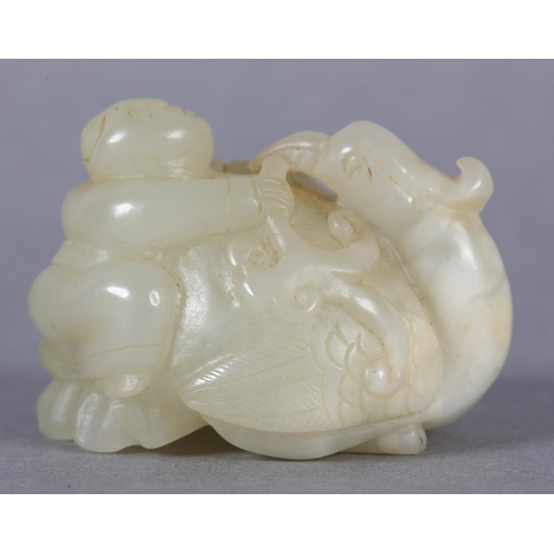 116 - A CHINESE JADE CARVING OF A BOY CLIMBING UPON THE BACK OF A PHOENIX with its head turned backwards h... 