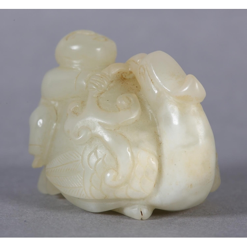 116 - A CHINESE JADE CARVING OF A BOY CLIMBING UPON THE BACK OF A PHOENIX with its head turned backwards h... 