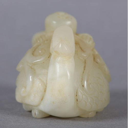 116 - A CHINESE JADE CARVING OF A BOY CLIMBING UPON THE BACK OF A PHOENIX with its head turned backwards h... 