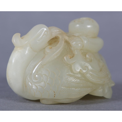 116 - A CHINESE JADE CARVING OF A BOY CLIMBING UPON THE BACK OF A PHOENIX with its head turned backwards h... 