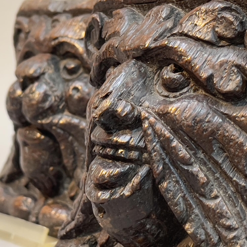 66 - A PAIR OF 18TH CENTURY OAK ANGLE BRACKETS CARVED AS A LION FACE MASK AND GREEN MAN FACE MASK, each w... 