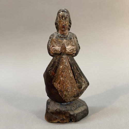 67 - AN 18TH CENTURY SPANISH COLONIAL PRIMITIVE POLYCHROME CARVED SANTOS FIGURE, of the Virgin Mary stand... 