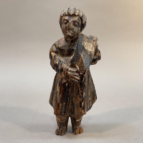 68 - AN 18TH/19TH CENTURY CARVED AND MONOCHROME PAINTED FIGURE OF AN APOSTLE, holding a scroll, 13cm high... 