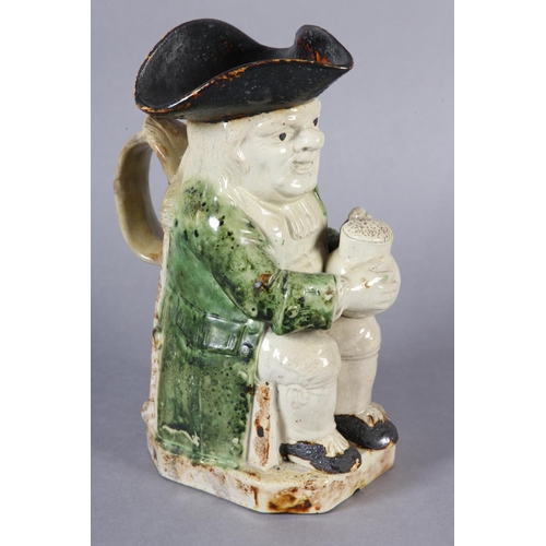 79 - A RALPH WOOD TYPE CREAMWARE TOBY JUG c1790-1800 of typical form, glazed in green and brown, 24cm hig... 