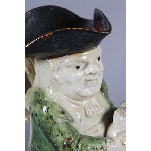 79 - A RALPH WOOD TYPE CREAMWARE TOBY JUG c1790-1800 of typical form, glazed in green and brown, 24cm hig... 