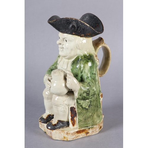 79 - A RALPH WOOD TYPE CREAMWARE TOBY JUG c1790-1800 of typical form, glazed in green and brown, 24cm hig... 